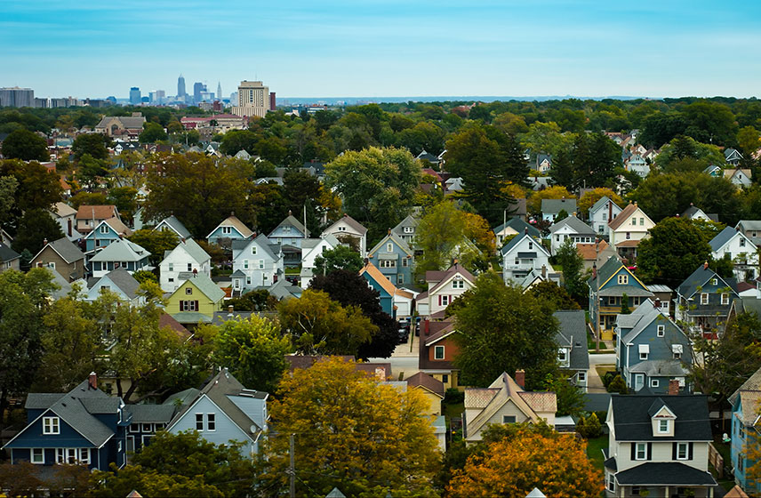 Suburban houses with city skyline in the background.
