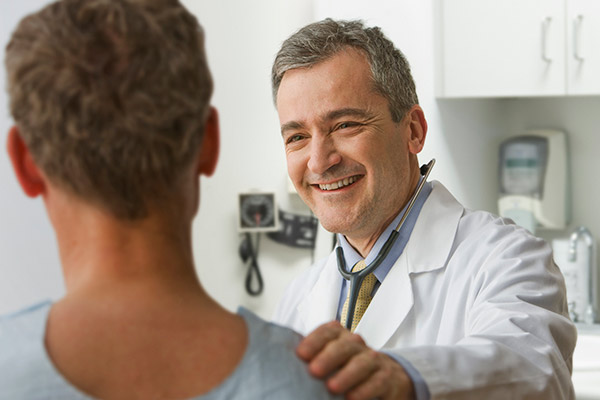 Clinician interacting with a patient in a comforting manner.