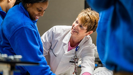 Nurse instructing a student.