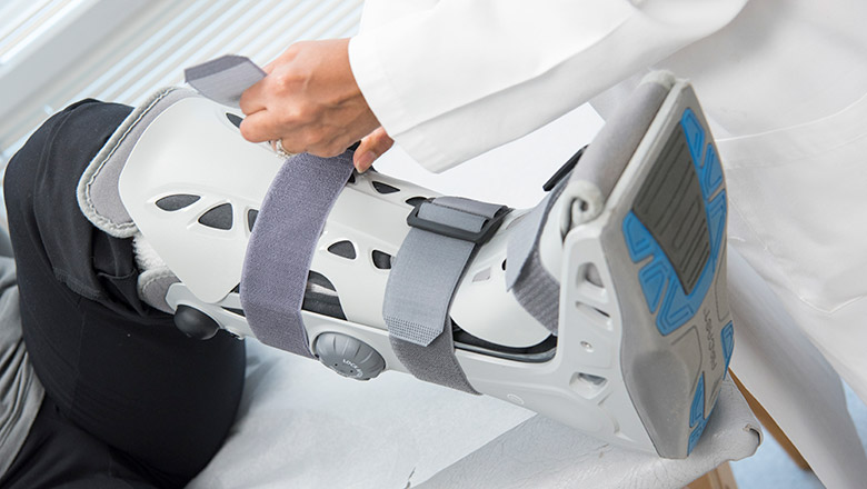Ortho Express Care provider placing boot on patient