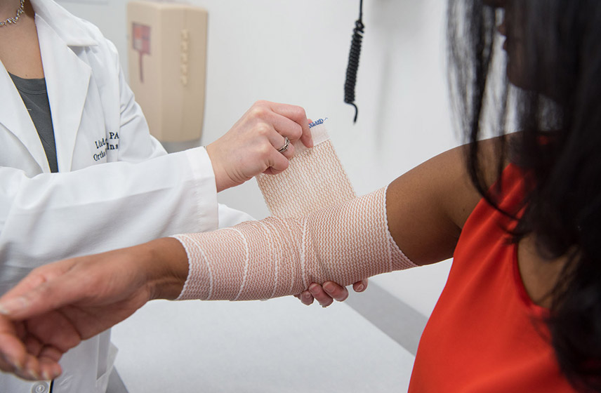 Provider checking child's arm for an injury