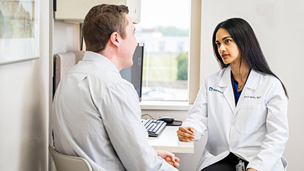 Cleveland Clinic doctor sitting with her patient.